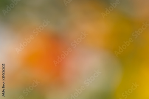 Abstract bokeh background with vibrant orange and yellow colors and blurry light spots. Dreamy soft focus texture for graphic design, web banners, and copy space.