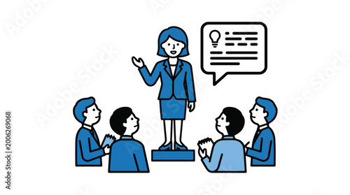 A confident female leader stands on a platform addressing a group of attentive colleagues in a meeting.