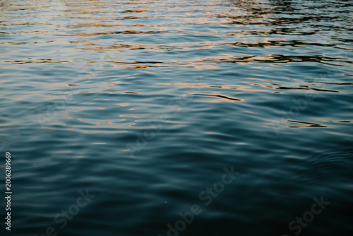 Fotografie water displays ripples as sunlight reflects off its surface