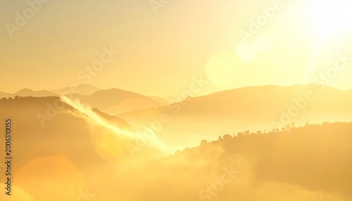 Golden sunrise over misty hills, soft light flooding landscape, creating a serene and warm atmosphere