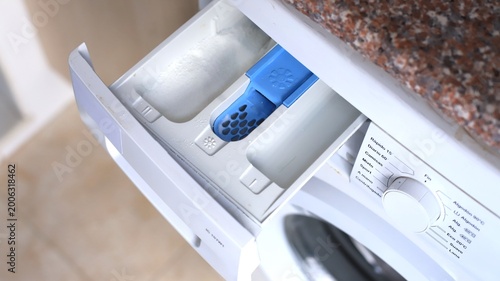 Photos Washing machine detergent drawer with blue compartment for fabric softener and w