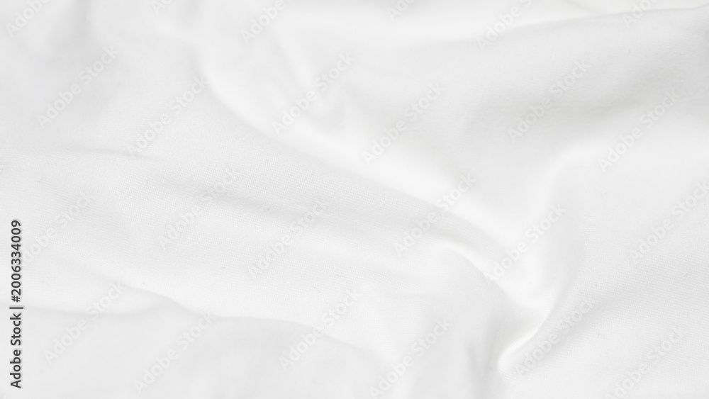 Fototapeta premium shot of a white fabric surface with a gentle horizontal fold and soft ripples