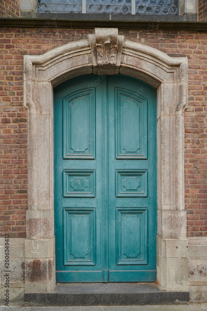 Fototapeta premium Teal door charms brick building