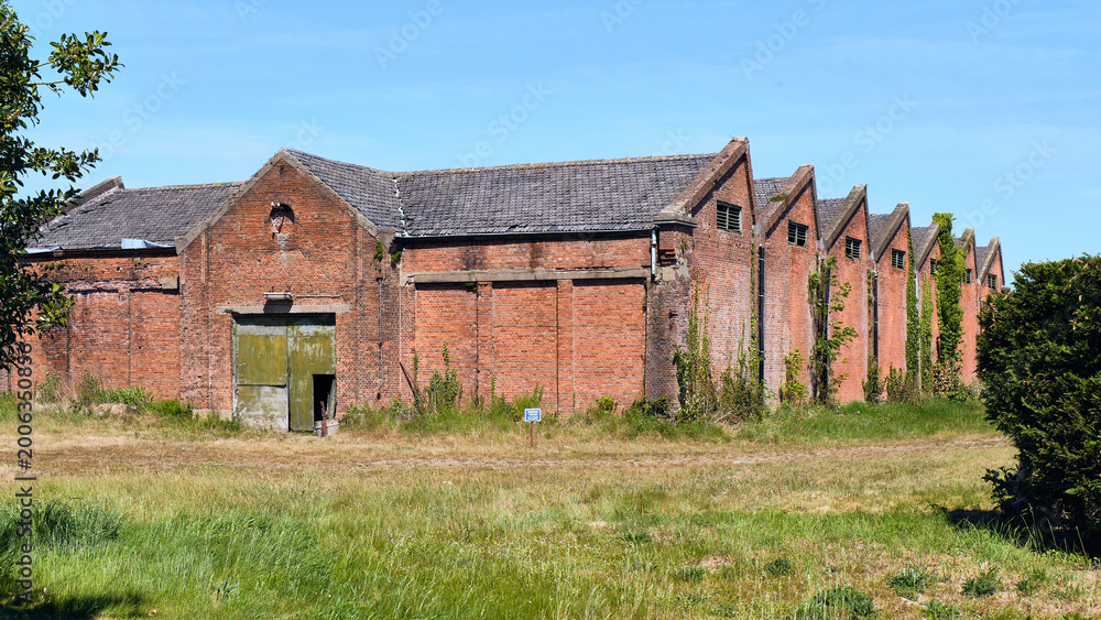 Obraz premium Rural Decline And Industrial Decay Old Tram Depot Building (tram remise Maldegem-Breskens) In Draaibrug Zeeland Netherlands Showing Economic Decline And Abandonment In A Rural Landscape