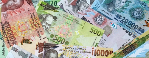 Photography Guinean franc money banknotes bunch on table