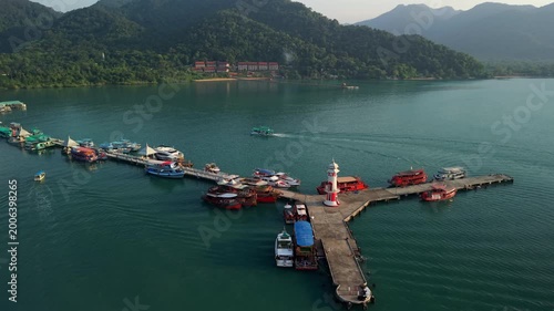 Aerial view of Bang Bao fishing village and pier, Ko Chang island, Thailand. Traditional coastal community with mountai