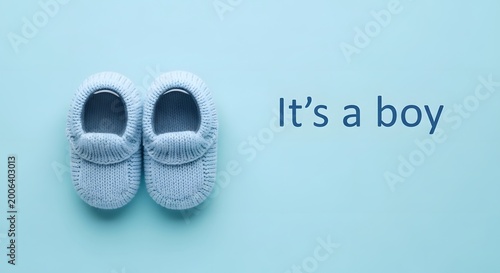 it's a boy announcement with blue knitted baby shoes on blue backgrouond.