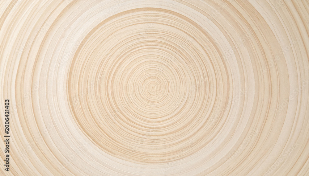 Fototapeta premium Minimalist natural wood background with elegant concentric circles, representing growth and the passage of time. Perfect for ecofriendly branding, textures, and modern organic designs.