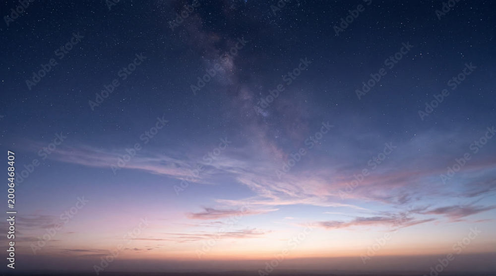 Obraz premium Milky Way Galaxy Over Beautiful Sunset Clouds in the Night Sky