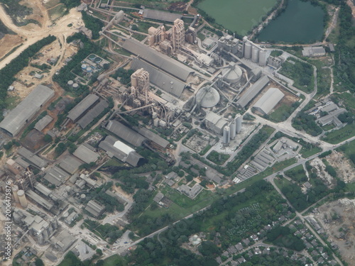 Bild auf Leinwand Industrial facility sprawls across green landscape