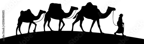 Valokuva Black Silhouette of a Camel Caravan and Leader Walking Across a Desert Horizon V
