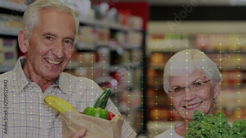 Senior duo holding bags in store aisle smiling as green grid sweeping, lighting produce for retail