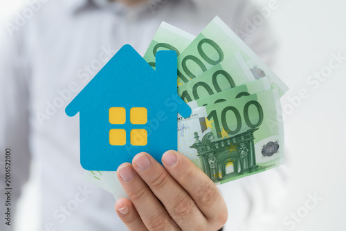 Person showing blue house s...