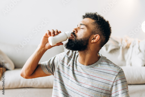 Εκτύπωση καμβά Man drinking probiotic yogurt for healthy lifestyle