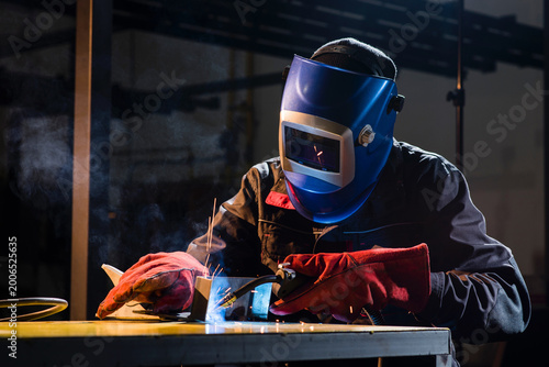 Crafting metal sparks in a workshop at night