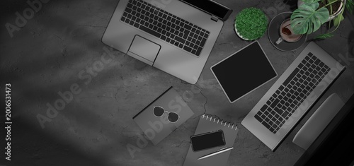 Modern Workspace with Laptop, Tablet, Smartphone, and Accessories on Dark Concrete Surface

