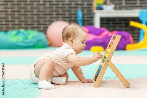 Baby Playing With Abacus In Daycare, Early Learning And Development Activity