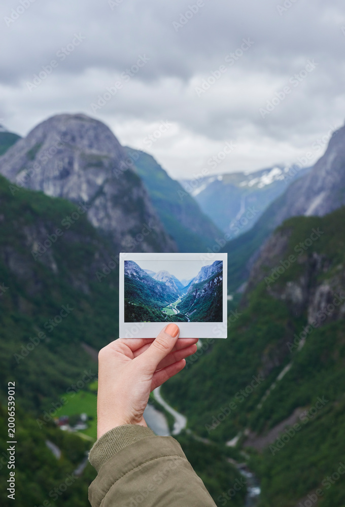 Fototapeta premium Person, hands or travel with photo of mountain landscape, location or destination in nature. Traveler, adventure trip or picture with natural scenery for outdoor memory, capture moment or photography