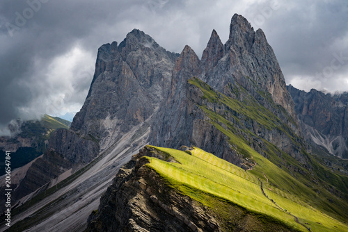 Seceda, Dolomites, Italy—lush green alpine ridge in South Tyrol under overcast sky. Scenic mountain landscape in the Alps, popular hiking and travel destination in Europe.