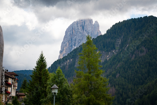 Town of Ortisei, Italy, gateway to Seceda and Alpe di Siusi,  with beautiful houses with flowers and church in dolomites