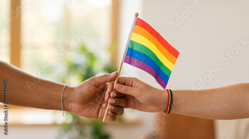 Hands holding rainbow flag lgbt pride diversity equality