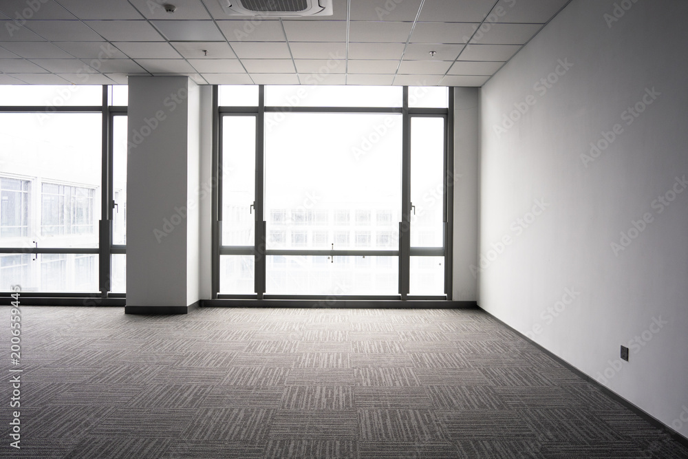 Fototapeta premium Spacious modern office interior with floor-to-ceiling windows and minimalist design