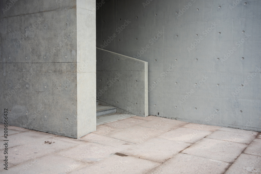 Fototapeta premium Exposed concrete architectural staircase interior with geometric structure and textured surfaces