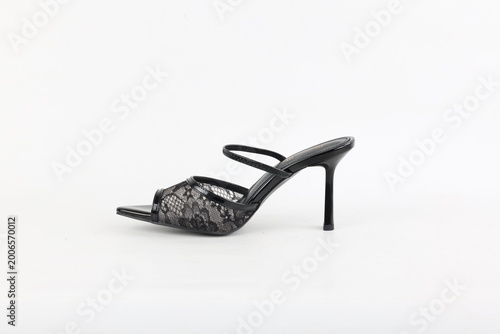 Black lace high heel mule isolated on white background, studio lighting highlighting elegant silhouette, delicate texture and modern feminine fashion design with minimal composition