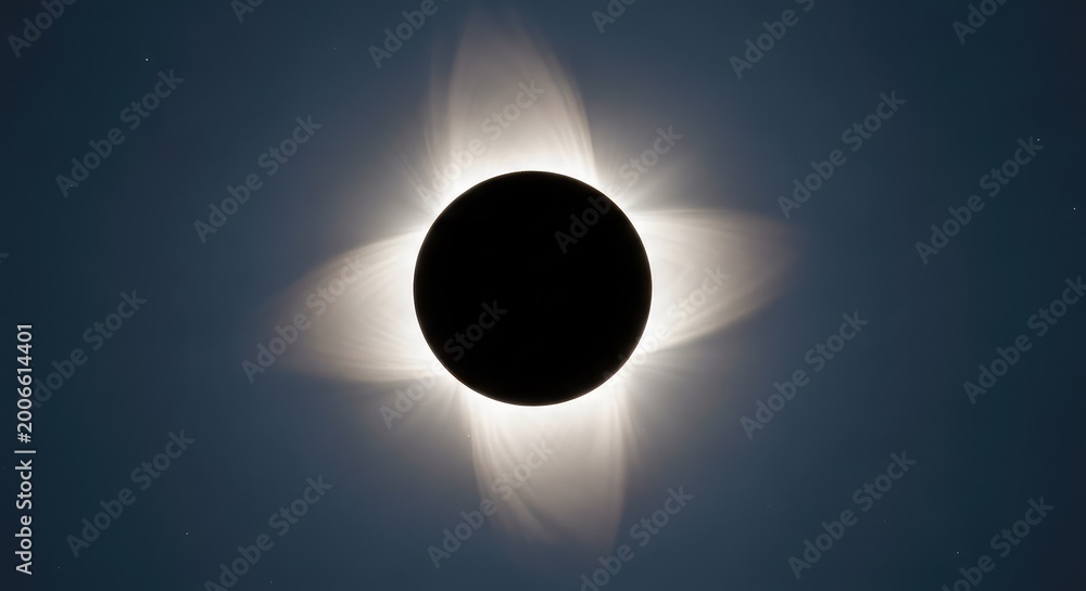 Obraz premium A total solar eclipse displays a glowing white corona around a black lunar silhouette against a dark sky filled with distant stars, sparkle, space, night