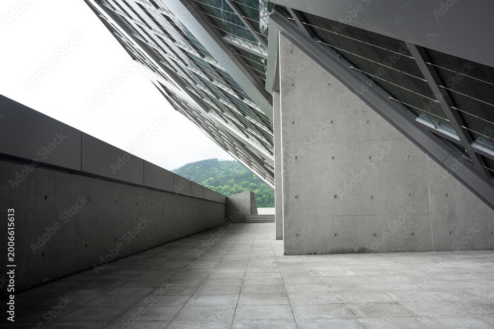 Fototapeta premium Modern architectural concrete corridor with glass roof structure and geometric design elements