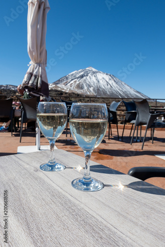 Tasting of white dry wine made in Tacoronte-Acentejo and Ycoden wine making areas on Tenerife with view on snow top of Mount Teide volcano, winter vacation, Spain