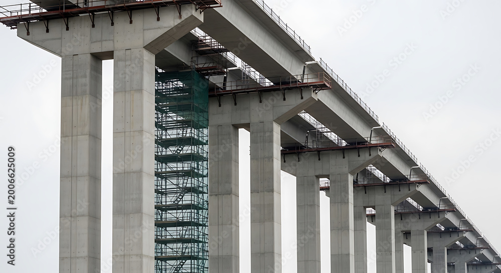 Naklejka premium Concrete bridge supports under construction detailed architectural photograph architecture pillars infrastructure