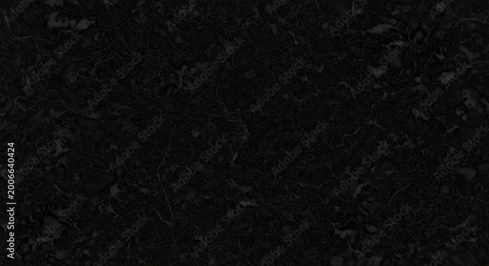 Fototapeta premium A dark, textured surface dominates the image. The surface appears rough and uneven, resembling stone or concrete.
