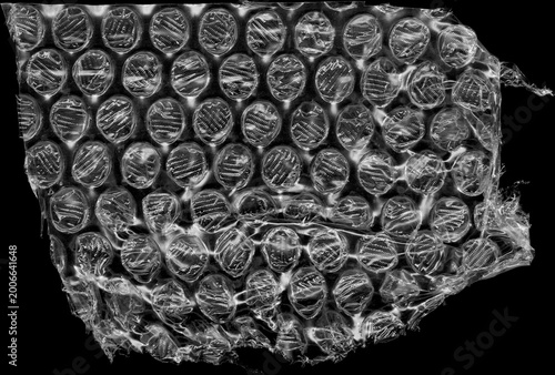 Bubble Wrap Textural Abstract: An intricate close-up showcasing the delicate, transparent structure of bubble wrap, creating a play of light, shadow, and texture.