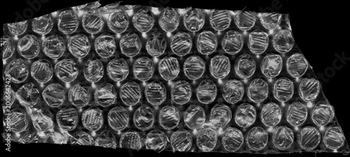 Bubble Wrap Texture: An abstract view of bubble wrap, a protective material, featuring a tactile texture with repeating circular air-filled pockets.