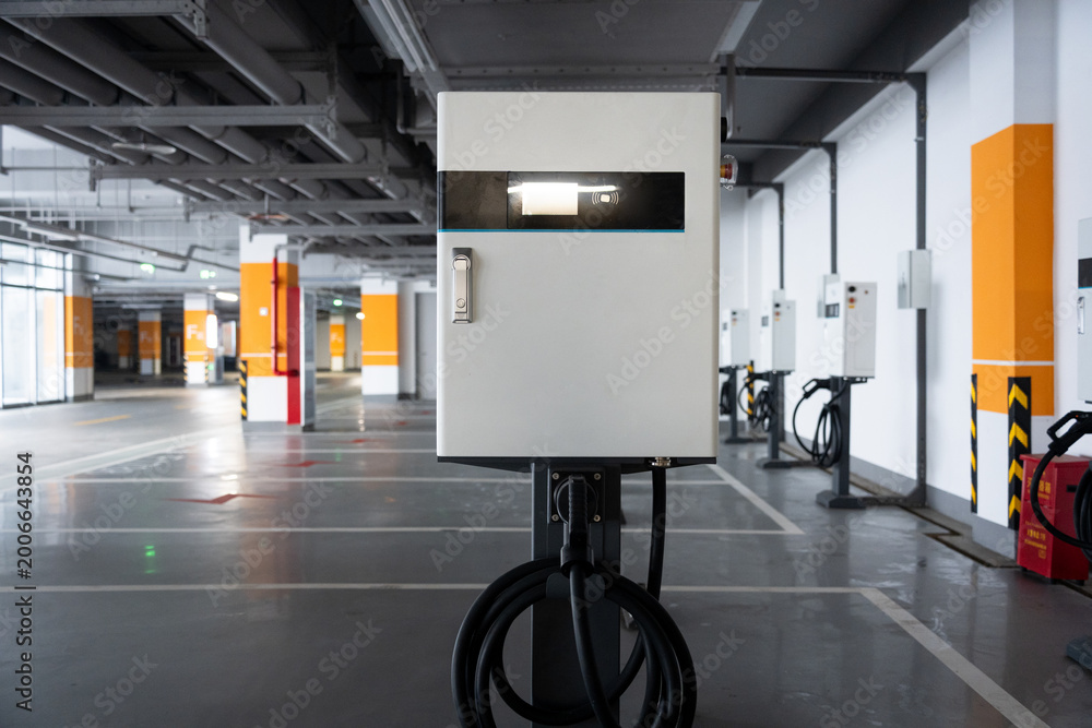 Fototapeta premium Electric vehicle charging station in an underground parking garage with modern infrastructure