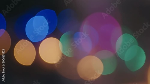 Colorful bokeh lights in darkness.