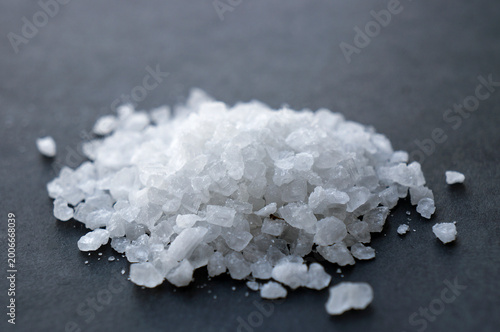 Fényképezés Close-up of a pile of coarse white sea salt crystals on a dark background