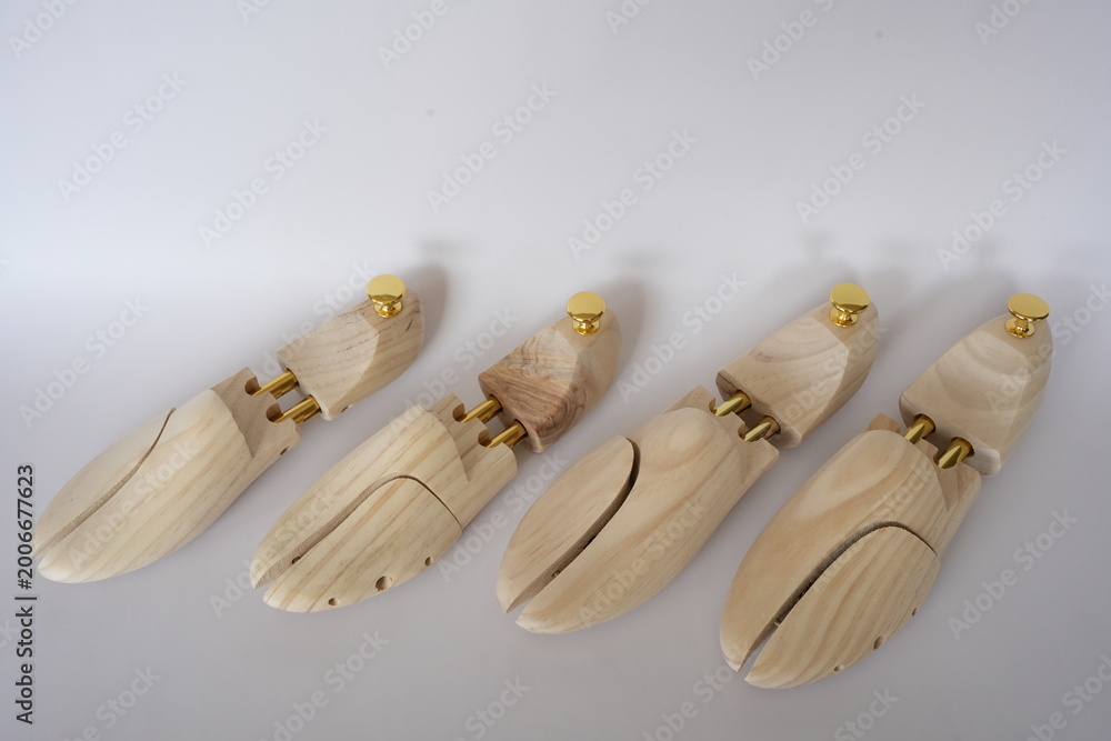 Fototapeta premium Professional wooden shoe trees for footwear on a white background