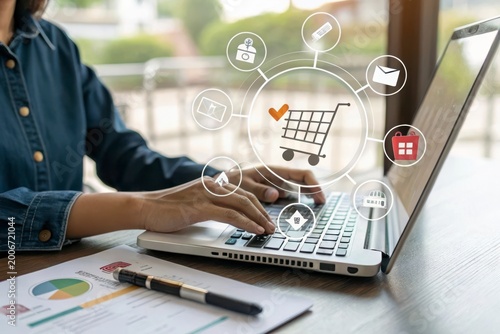 Person hands typing on laptop computer with online shopping icons overlaying the screen showing process