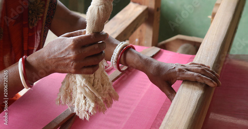 Billede på lærred Handloom weaver in India working in loom.