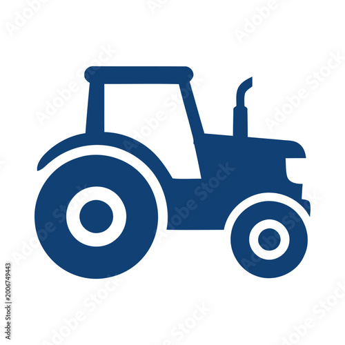 A blue tractor is driving on a rural road in the countryside landscape.