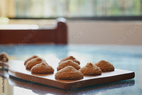 Freshly baked sugar cookies on wooden board