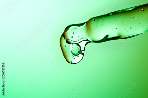 Konstfotografi Peptide serum dropping from pipette for biotech skincare