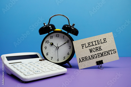 Flexible Work Arrangements text with calculator and alarm clock on blue and purple background