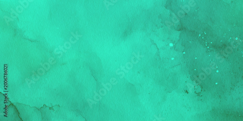 Photos Vibrant green watercolor background with dark splatters and texture