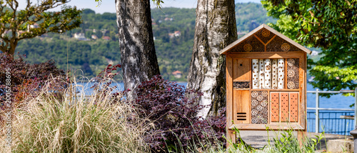 Fotografija Wooden insect hotel in a lakeside garden, nature habitat shelter, outdoor ecolog