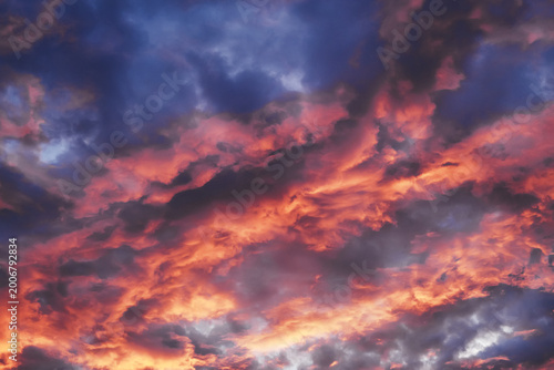 Colorful evening sky with orange and purple cumulus clouds creating dramatic background