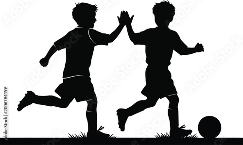 Konstfotografi Two boys in silhouette giving a high five while playing soccer