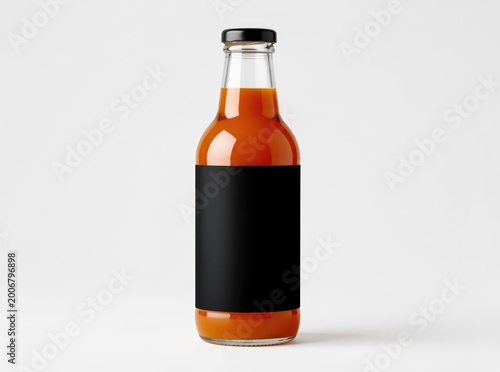 A close-up photo of a hot sauce bottle with a black label